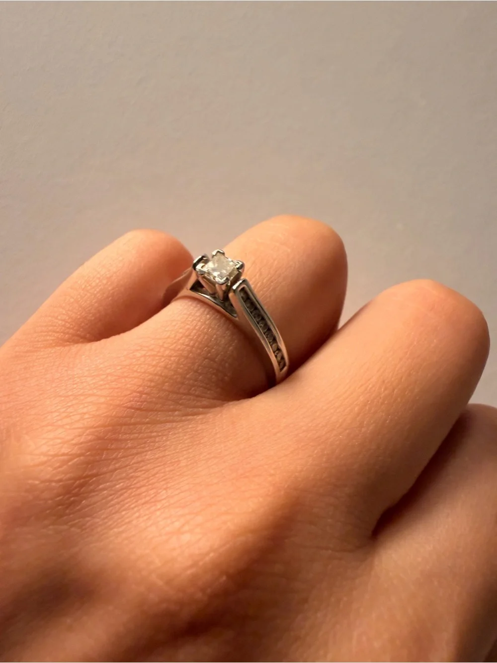 14k white gold with a 1 carat diamond princess cut ring.